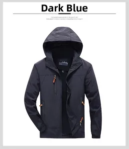 Close-up of a navy outdoor hooded jacket with chest zipper pocket and adjustable cuffs