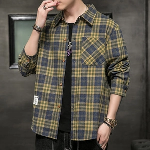 Close-up of men's yellow and grey plaid flannel shirt with front pocket and collar