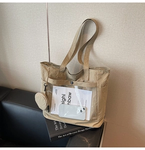 Detail of khaki nylon tote bag featuring transparent PVC pocket and round mini coin purse