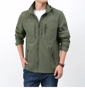Detail of army green waterproof outdoor jacket with embroidered badge on the left sleeve