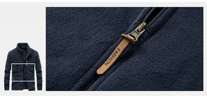 Gros plan de la fermeture éclair en métal avec tirette en cuir marron sur veste