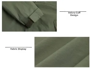 Detail of adjustable velcro cuffs and water-resistant windbreaker fabric on army green jacket