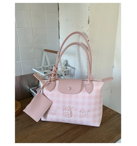 Close-up of pink checkered canvas tote with cute cartoon bread prints and mini purse