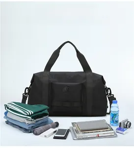 Close-up of a large black travel bag interior showing packed clothes and gear