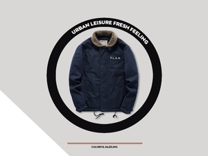 Close-up of navy blue jacket featuring brown sherpa collar and white P.L.A.N. lettering