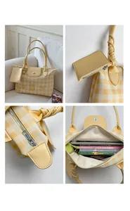 Detail view of plaid tote bag featuring smooth zippers and spacious interior capacity