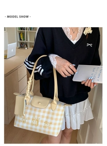 Detail of yellow checkered tote bag with cute cartoon bear embroidery and matching coin purse