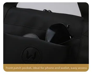 Close-up of durable black nylon travel bag featuring a front pocket for phone and wallet