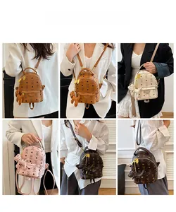 Multi-angle view of mini PU leather backpacks with monogram patterns and plush charms