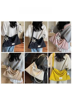 Detail view of large canvas tote bags in five colors with star pendant decoration