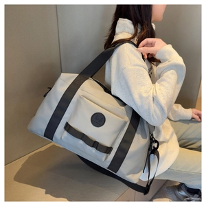 Macro detail of spacious grey travel duffel bag showing durable nylon texture and handle