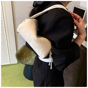 Detail of off-white pleated shoulder bag showing fine texture and fashion logo
