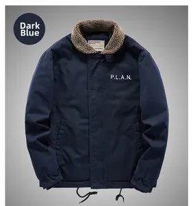 Close-up of dark blue jacket with brown faux shearling collar and P.L.A.N. print