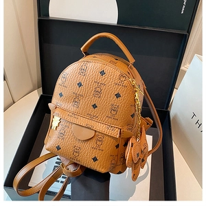 Detailed view of mini teddy bear backpack with heart flap pocket and cute bear charm
