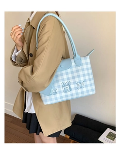 Detail view of a large plaid tote bag with cute bear and bread illustrations in light blue