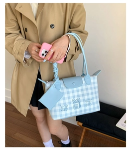 Detail of blue and white checkered tote bag with cartoon print and mini coin purse
