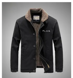 Detail of navy deck jacket with brown fleece collar and PLAN embroidery on chest