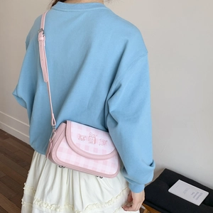 Pink and white checkered crossbody bag featuring a cute rabbit illustration on a model