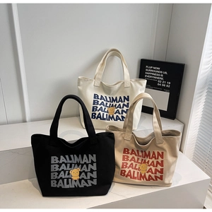 Three large canvas tote bags in black, white, and khaki with cute bear print and logo