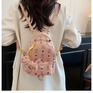 Detail of pink mini backpack with black teddy bear print and matching bear charm