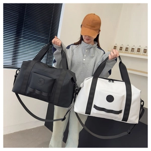 Detail view of high-capacity travel bags in black and white with waterproof nylon material