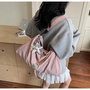 Pink pleated nylon shoulder bag featuring a large silver sequined star charm detail