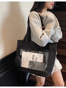 Black canvas tote bag with transparent PVC front pocket and small round coin purse