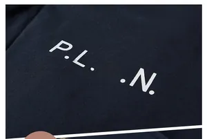 Detailed close-up of white P.L.A.N. print on navy lambswool jacket fabric texture