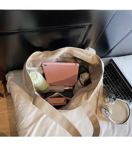 Top view of beige canvas tote bag interior showing large capacity and zipper pocket