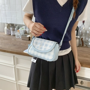 Detail of light blue gingham crossbody bag featuring cute rabbit embroidery detail