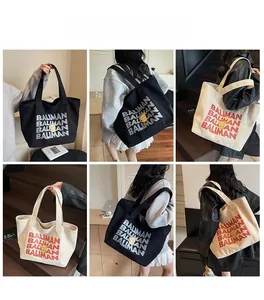 Detail view of large canvas tote bag with BALIMAN bear print in black and off-white colors