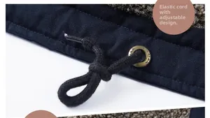 Detailed macro view of the adjustable drawstring hem and metal eyelets on the navy jacket