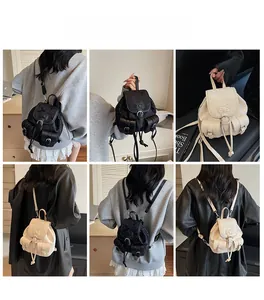 Detail view of mini leather backpack featuring drawstring closure and signature bow logo
