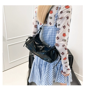 Dettaglio borsa hobo in pelle verniciata nera con nodo laterale e zip in metallo