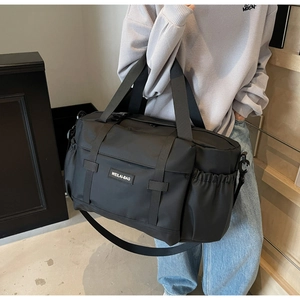 Détail du grand sac de voyage noir imperméable avec poche à boucle et cordon latéral
