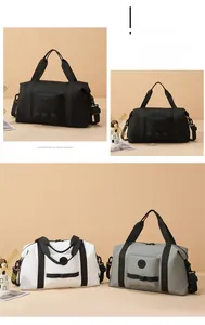 Detail of travel duffel bag showing reinforced handles and front zipper storage pocket