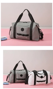 Detail view of large travel duffel bag with reinforced handles and waterproof fabric texture