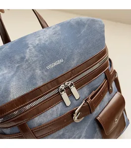 Detailed close-up of blue denim backpack with premium leather trim and silver metal zippers