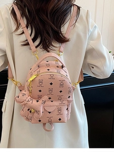 Pink mini backpack with teddy bear prints and dog pendant on model back