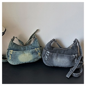 Detail of blue and charcoal distressed denim crescent bags with vintage Y2K aesthetic