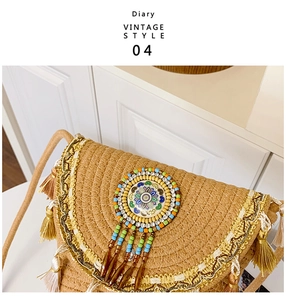 Detail of woven straw bucket bag with ethnic beads, tassels and vintage braided strap