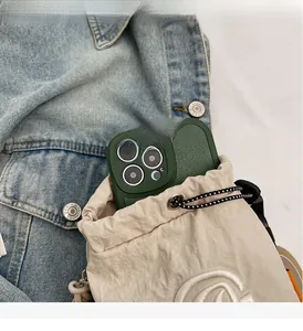 Detail of beige nylon drawstring bag showing interior capacity with a green phone case inside