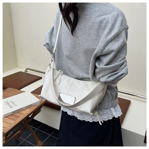 Minimalist white leather crossbody tote shown on model for a stylish casual daily commute