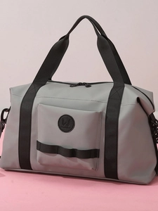 Light grey waterproof travel duffel bag with black handles on a minimalist background