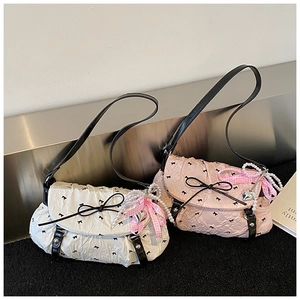 Detail of bow-patterned shoulder bags featuring pearl chains and heart charms