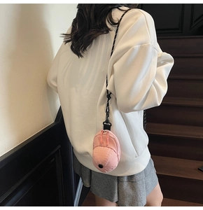 Detail of pink baseball cap shaped mini bag with checkered fabric and double zippers