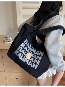 Large black canvas tote bag with BALIMAN text and yellow bear print for school use