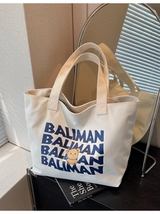Large white canvas tote bag with blue Baliman lettering and cute cartoon bear graphic