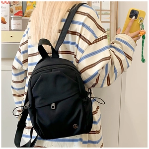 Detail of compact black waterproof nylon mini backpack with adjustable shoulder straps