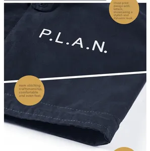 Detail of P.L.A.N. letter print and reinforced double stitching on navy cotton jacket